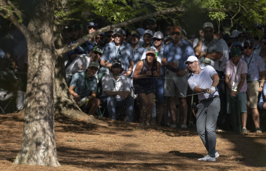 Masters champion Rory McIlroy of Northern Ireland hits a stroke from the pine straw at No. 13 during the second round of the Masters at Augusta National Golf Club