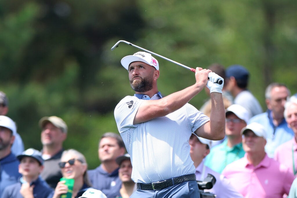 Jon Rahm of Spain plays his shot from the fourth tee during the Par Three Contest prior to the 2026 Masters Tournament at Augusta National Golf Club