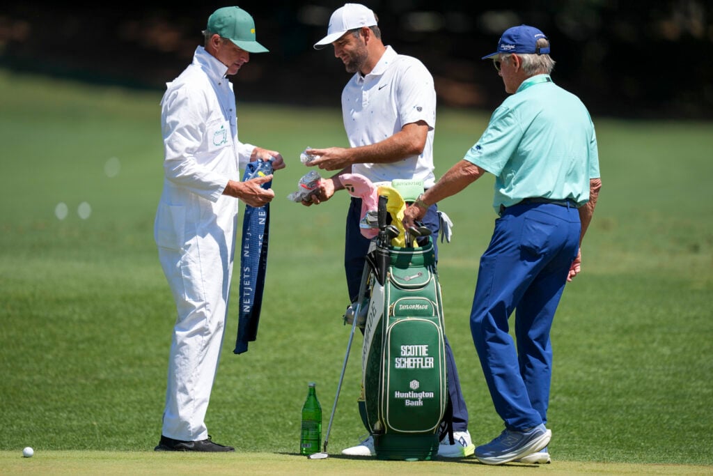 Scottie Scheffler with Ted Scott and Randy Smith on the range ahead of the final round of The Masters