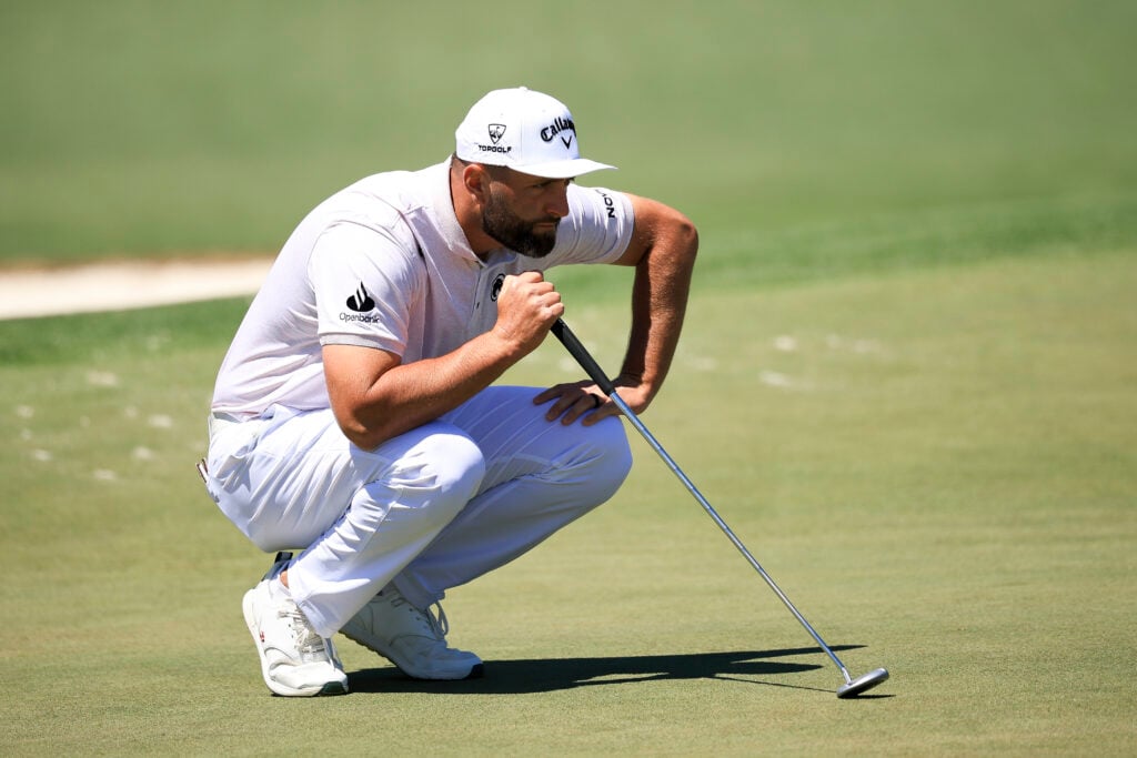 Jon Rahm lines up a putt during the first round of The Masters