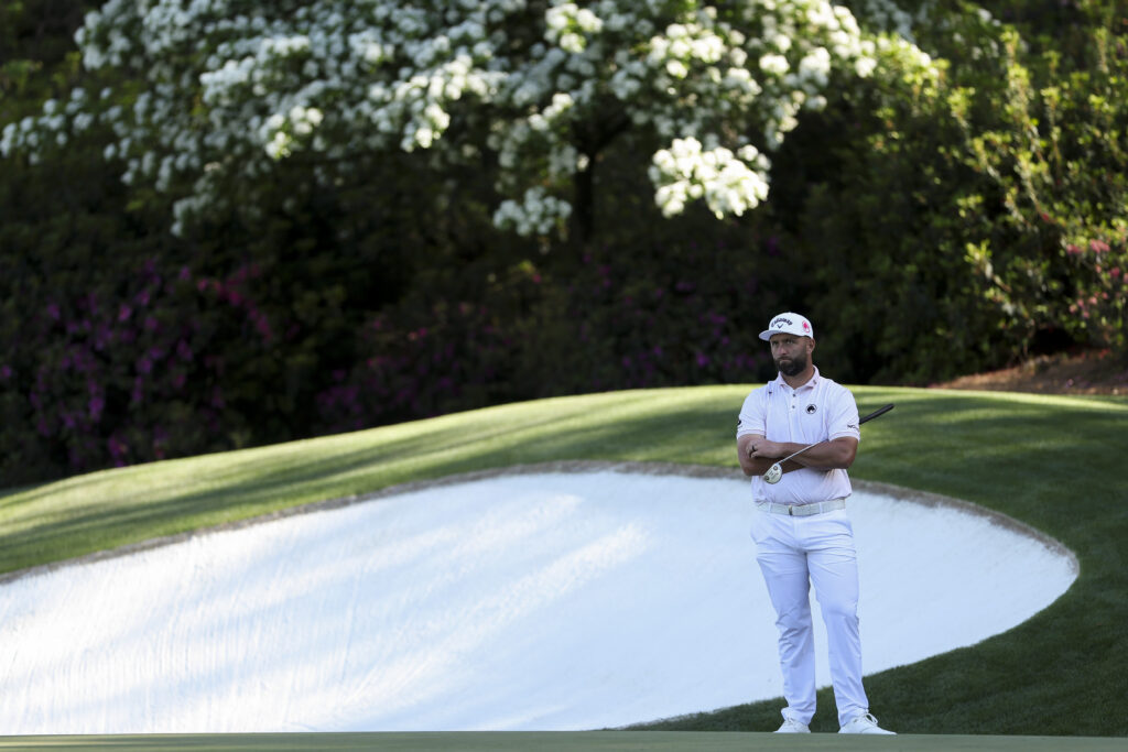 Jon Rahm waits by the 13th green during the first round of The Masters