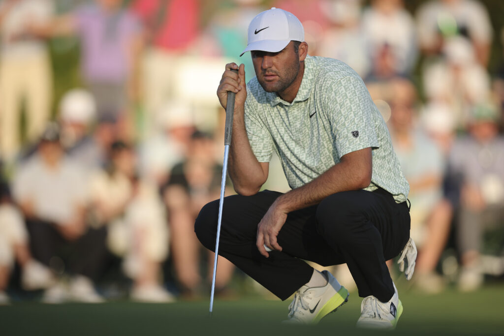 Scottie Scheffler of the United States lines up a putt on the 18th green during the first round of the 2026 Masters Tournament at Augusta National Golf Club