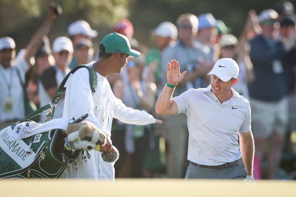 Rory McIlroy of Northern Ireland and his caddie Harry Diamond react on the 17th green during the second round of the 2026 Masters Tournament at Augusta National Golf Club
