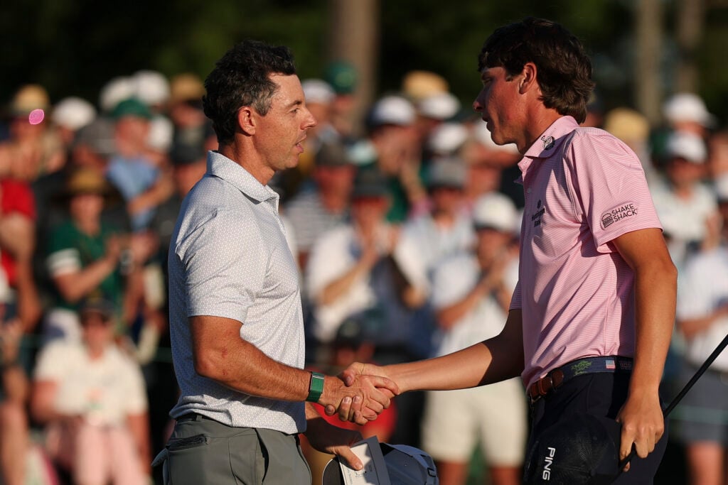 Rory McIlroy and Mason Howell shake hands after the second round at The Masters