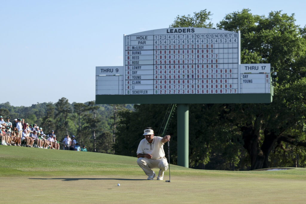 Jason Day lines up a putt on the 18th hole during the third round of The Masters