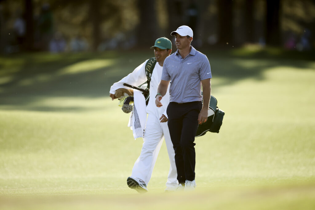 Rory McIlroy and Harry Diamond walk up the 17th hole during the third round at The Masters