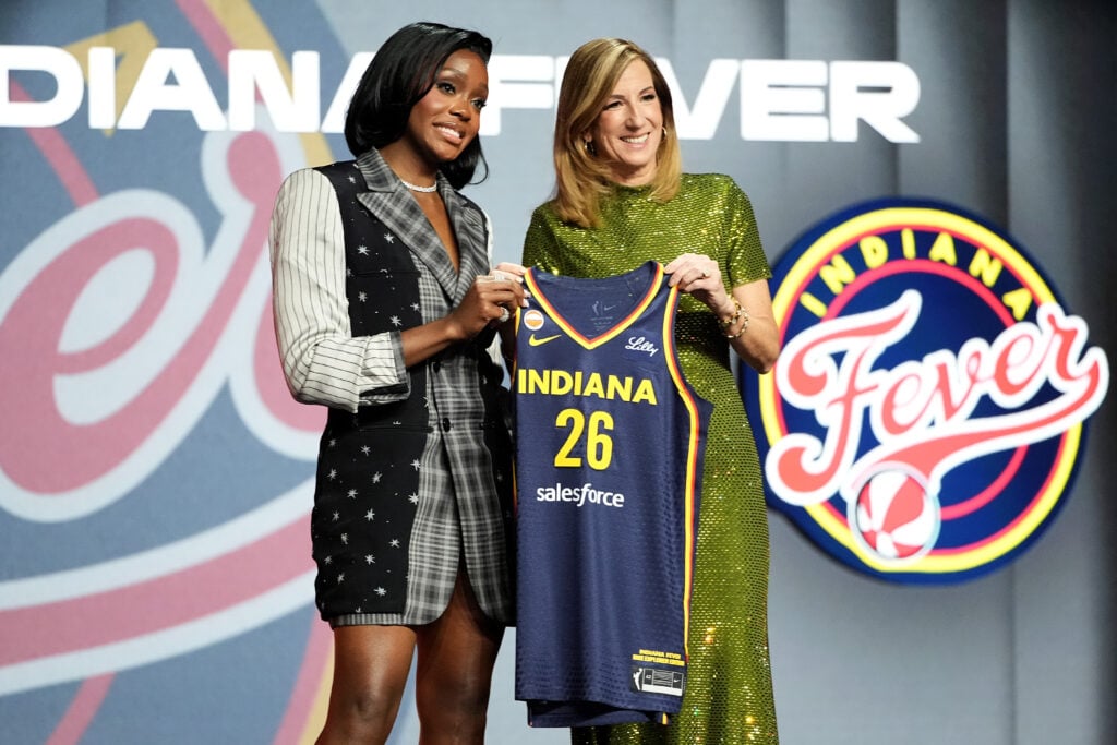 Raven Johnson (L) of South Carolina poses with WNBA Commissioner Cathy Engelbert (R) after being selected with the 10th pick in the first round by the Indiana Fever during the 2026 WNBA Draft at The Shed.