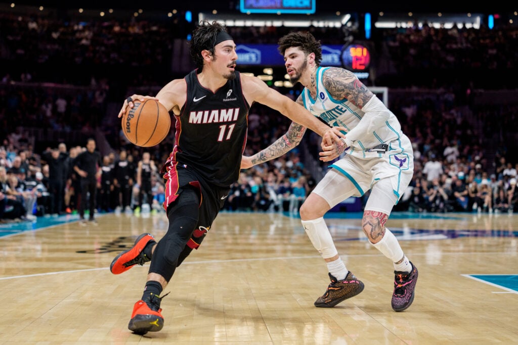Jaime Jaquez Jr. #11 of the Miami Heat brings the ball up court while guarded by LaMelo Ball #1 of the Charlotte Hornets in the second half during their game at Spectrum Center.