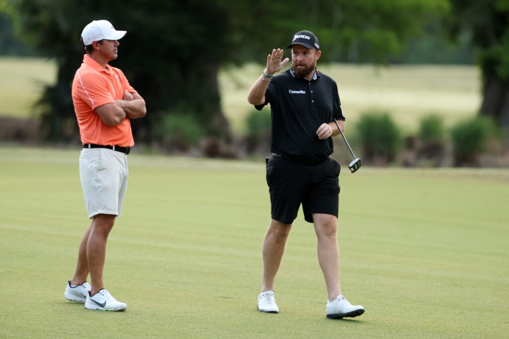 Brooks Koepka of the United States and Shane Lowry of Ireland speak on the first fairway prior to the Zurich Classic of New Orleans 2026 at TPC Louisiana