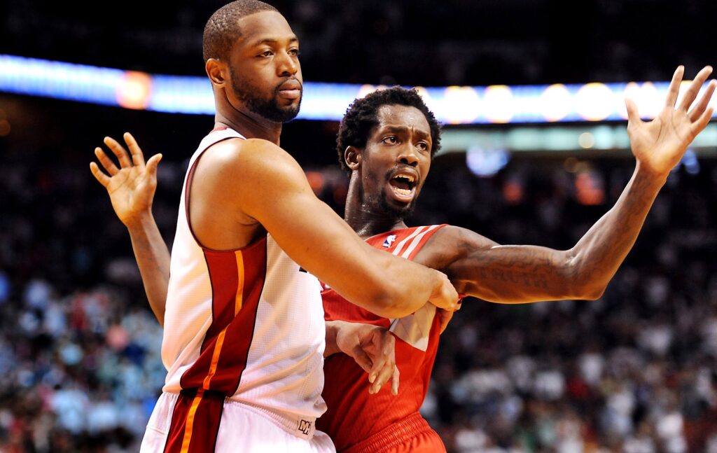 Miami Heat's Dwyane Wade pushes off Houston Rocket's Patrick Beverly, who was fighting for position with Wade for an in-bounds pass at the American Airlines Arena.