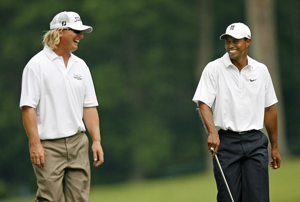 Tiger Woods and Charley Hoffman joke during the first round of The Memorial