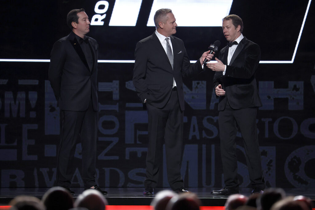 Host Marty Snider (C) interviews NASCAR Cup Series drivers, Brad Keselowski(R) and Kyle Busch onstage during the NASCAR Awards and Champion Celebration at the Music City Center on November 30, 2023 in Nashville, Tennessee.