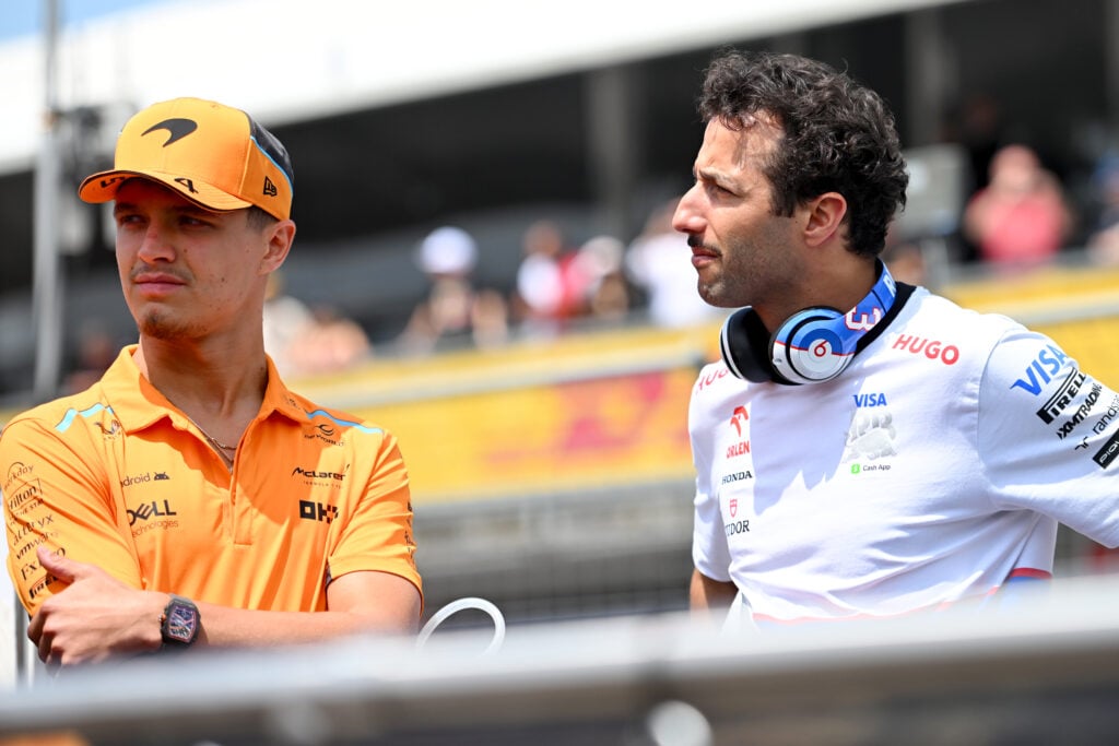 Daniel Ricciardo of Australia and Visa Cash App RB and Lando Norris of Great Britain and McLaren talk on the drivers parade prior to the F1 Grand Prix of Emilia-Romagna at Autodromo Enzo e Dino Ferrari Circuit on May 19, 2024 in Imola, Italy.