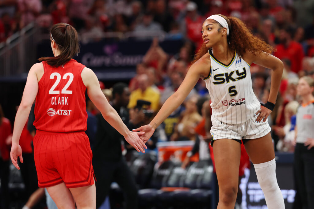 Angel Reese #5 of the Chicago Sky and Caitlin Clark #22 of the Indiana Fever meet at mid court prior to tipoff for the Fever's home opener at Gainbridge Fieldhouse.