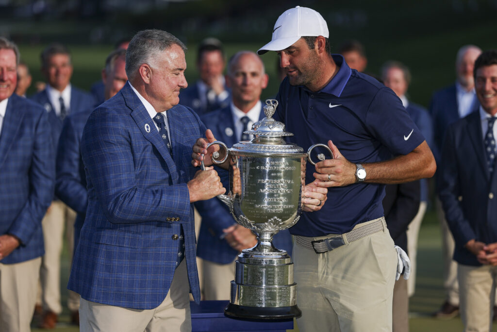 Don Rea Jr., PGA of America President, hands Scottie Scheffler of the United States the Wanamaker Trophy during the trophy presentation after the final round of the PGA Championship at Quail Hollow Country Club