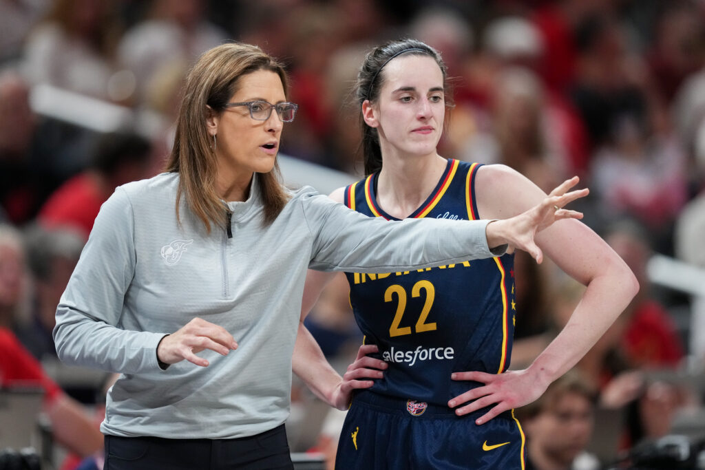 Head coach Stephanie White and Caitlin Clark #22 of the Indiana Fever meet in the second quarter against the Connecticut Sun at Gainbridge Fieldhouse.