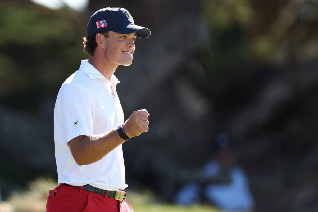 Jackson Koivun of Team United States reacts on the 15th green after defeating Tyler Weaver of Team Great Britain and Ireland in Saturday singles during Day One of The 50th Walker Cup at Cypress Point