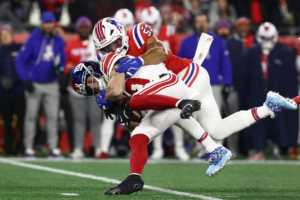 Gunner Olszewski #80 of the New York Giants is tackled by Christian Elliss #53 of the New England Patriots during the game at Gillette Stadium on December 2, 2025 in Foxborough.
