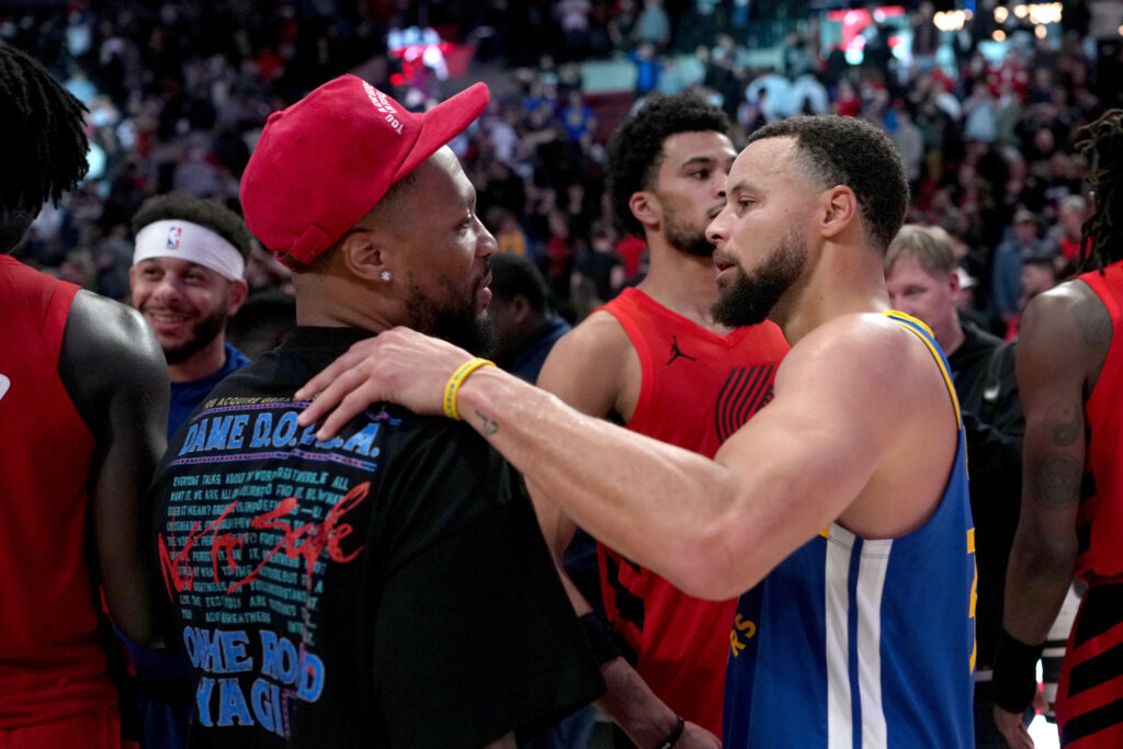 Damian Lillard #0 of the Portland Trail Blazers and Stephen Curry #30 of the Golden State Warriors talk after the game at Moda Center.