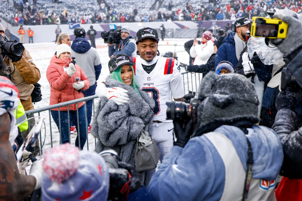 Cardi B and Stefon Diggs #8 of the New England Patriots celebrate after the AFC Championship game against the Denver Broncos at Empower Field At Mile High.