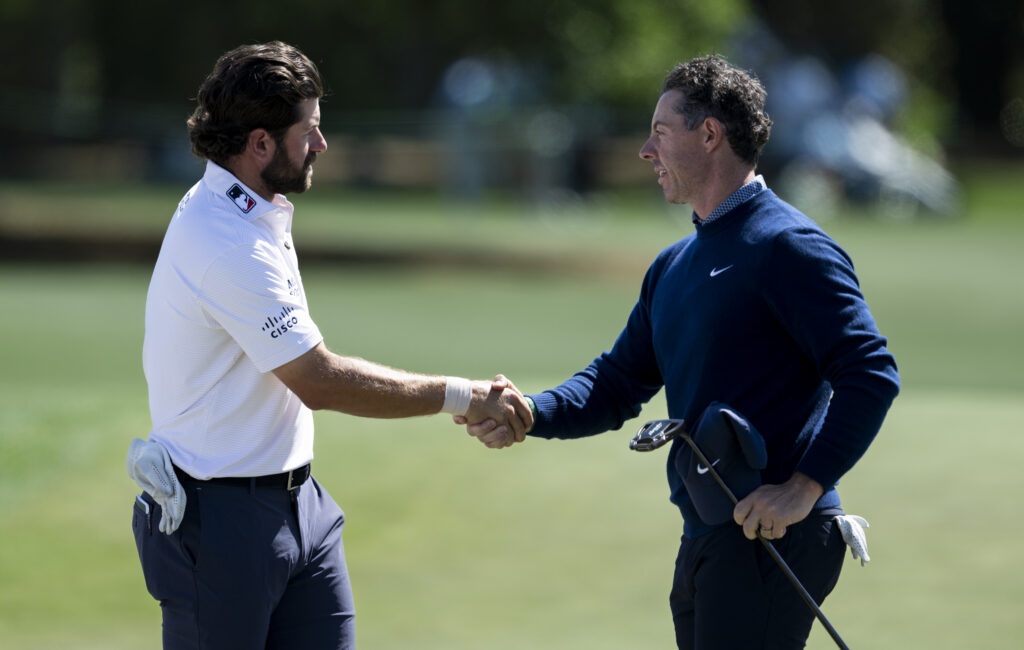 Cameron Young and Rory McIlroy shake hands after the first round of The Masters