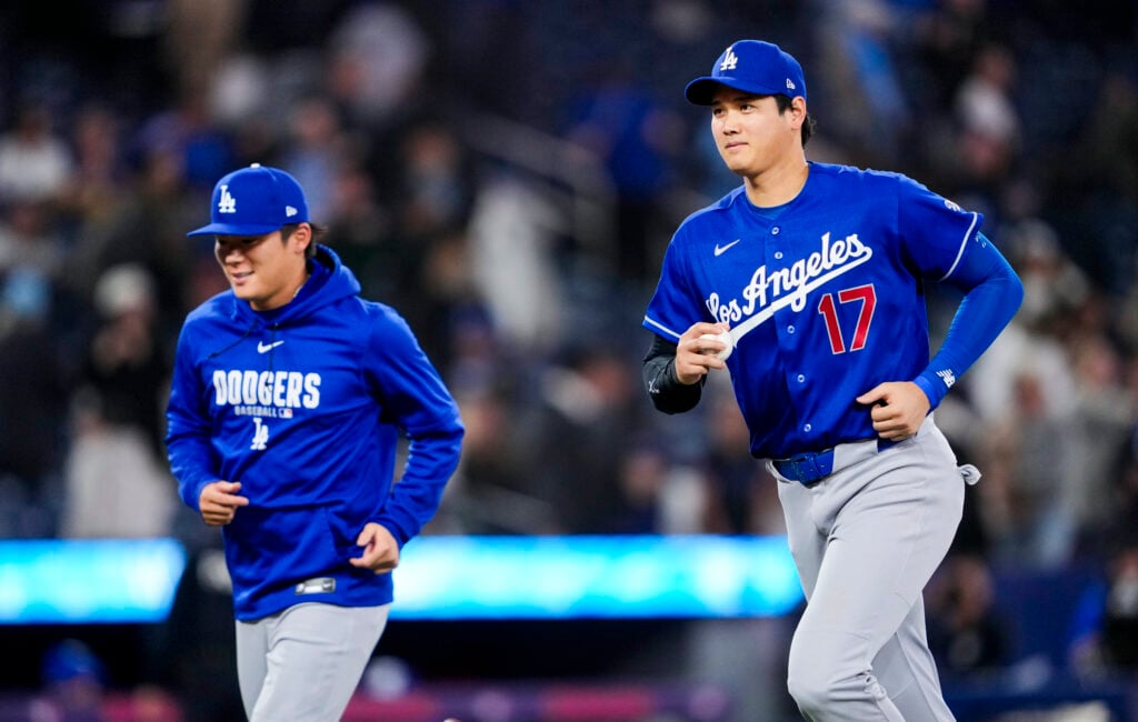 Shohei Ohtani #17 of the Los Angeles Dodgers runs off the field with teammate Yoshinobu Yamamoto #18 after their team defeated Toronto Blue Jays in their MLB game at the Rogers Centre on April 6, 2026 in Toronto, Ontario, Canada.