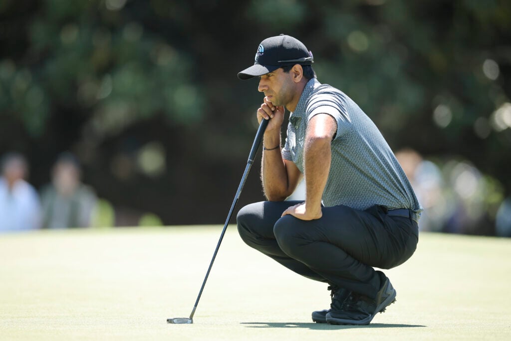 Aaron Rai lines up a putt during the first round of The Masters