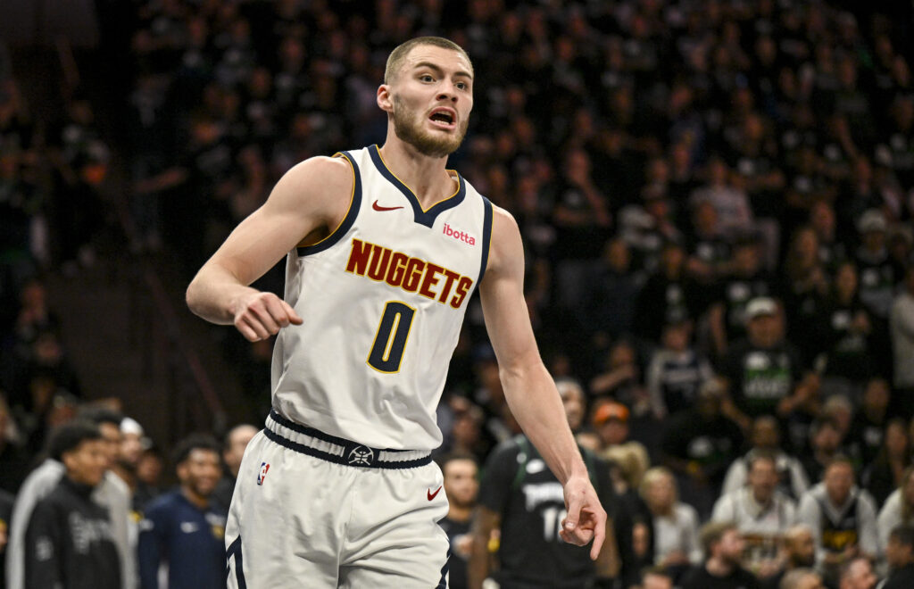 Christian Braun (0) of the Denver Nuggets calls for possession after poking the ball away from Jaden McDaniels (3) of the Minnesota Timberwolves during the second quarter of Game 6 of their NBA Playoffs series at the Target Center.