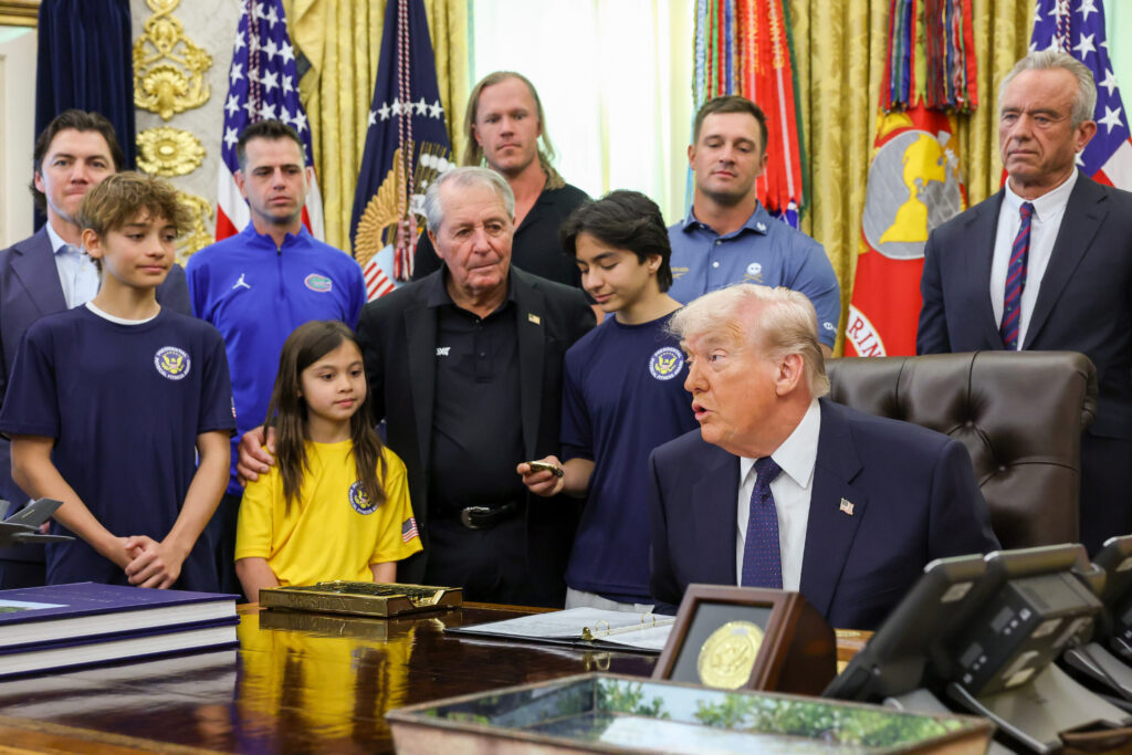 President Donald Trump is joined by (L-R) former NHL player T. J. Oshie, head coach of the Florida Gators men's basketball team Todd Golden, retired professional golfer Gary Player, MLB pitcher Noah Syndergaard, professional golfer Bryson DeChambeau, U.S. Secretary of Health and Human Services Robert F. Kennedy Jr. and young athletes as he speaks during a proclamation signing in the Oval Office of the White House.