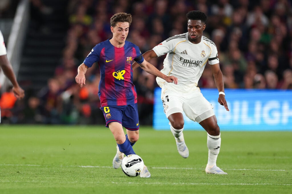 Gavi of FC Barcelona in action with Aurelien Tchouameni of Real Madrid CF during the LaLiga EA Sports match between FC Barcelona v Real Madrid at the Camp Nou.