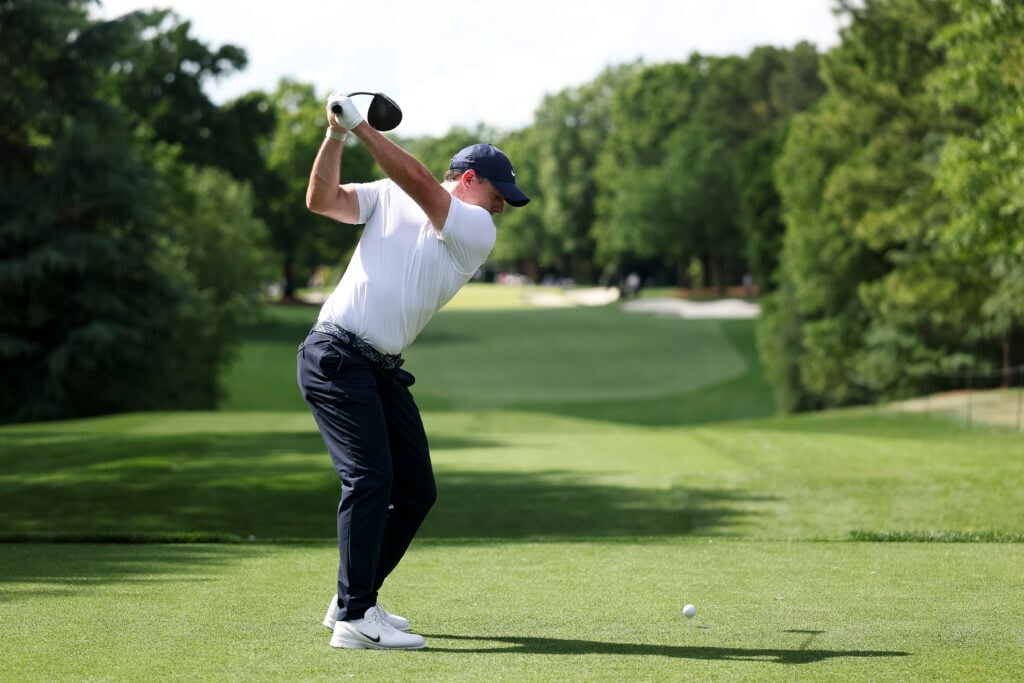 Rory McIlroy hits a tee shot on the third hole during the first round of the Truist Championship at Quail Hollow