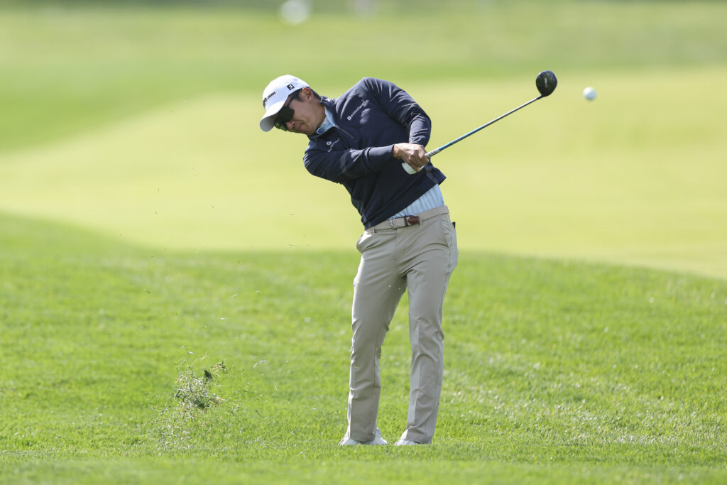 Michael Kim hits his shot on the 16th hole during the PGA Championship Practice Round at Aronimink Golf Club