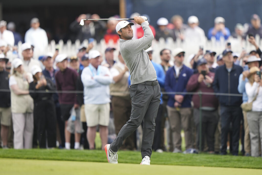 Scottie Scheffler hits an approach shot during the opening round of the PGA Championship at Aronimink