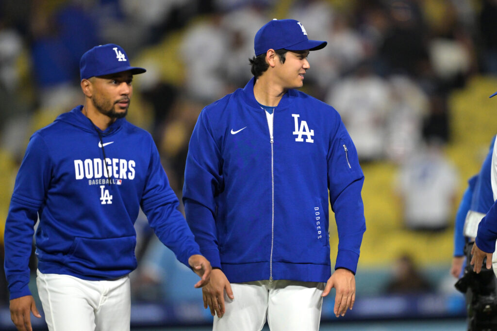 Shohei Ohtani #17 of the Los Angeles Dodgers walks off the field with Mookie Betts #50 following the game against the San Francisco Giants at Dodger Stadium.
