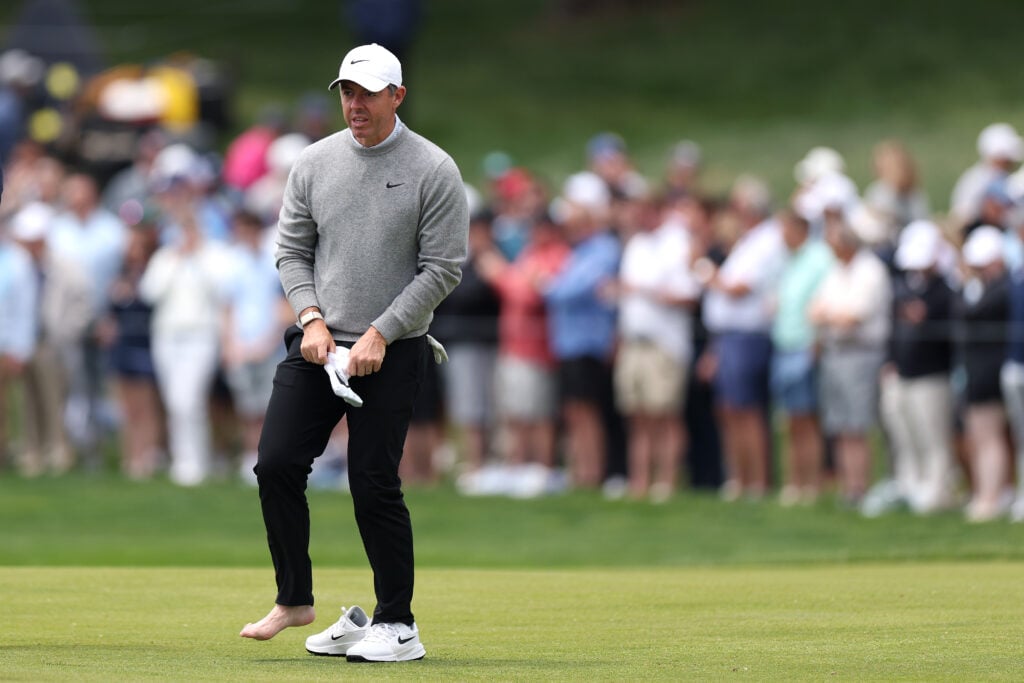 Rory McIlroy puts his sock back on during a practice round at Aronimink ahead of the PGA Championship