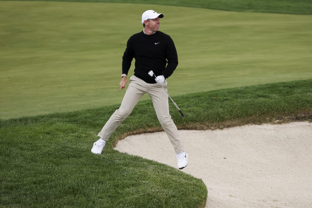Rory McIlroy watches his shot from the bunker during the first round of the PGA Championship
