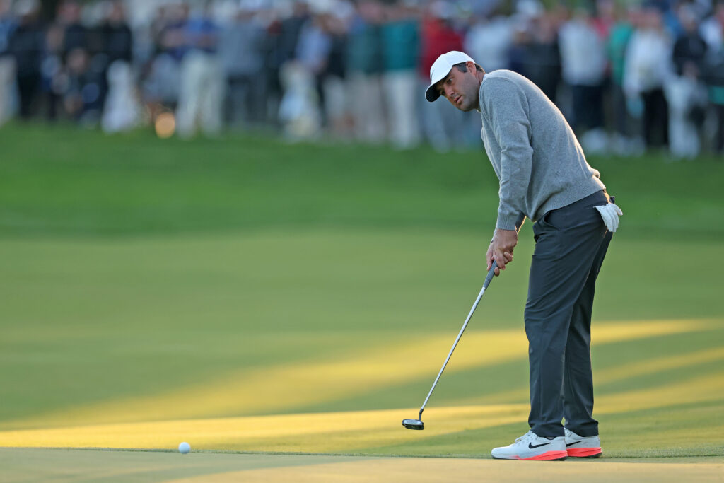 Scottie Scheffler of the United States putts on the 18th green during the first round of the PGA Championship at Aronimink Golf Club