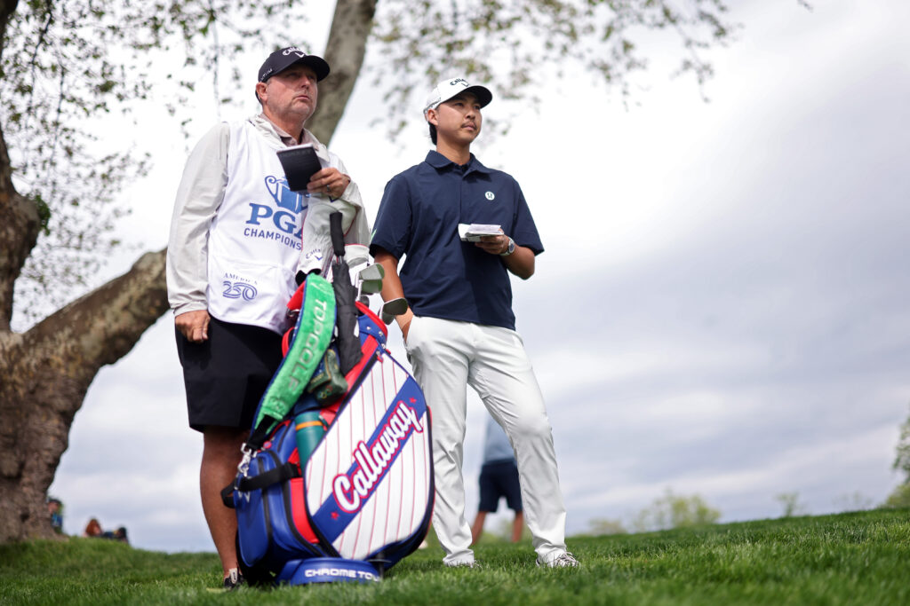 Min Woo Lee of Australia and his caddie Shane Joel look on from the tenth hole during the second round of the PGA Championship at Aronimink Golf Club