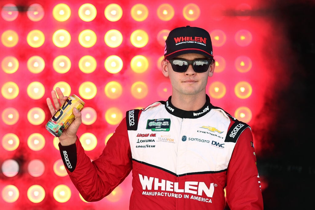 Jesse Love, driver of the #2 Whelen Chevrolet, waves to fans as he walks onstage during driver intros prior to the NASCAR O'Reilly Auto Parts Series BetRivers 200 at Dover Motor Speedway on May 16, 2026 in Dover, Delaware.