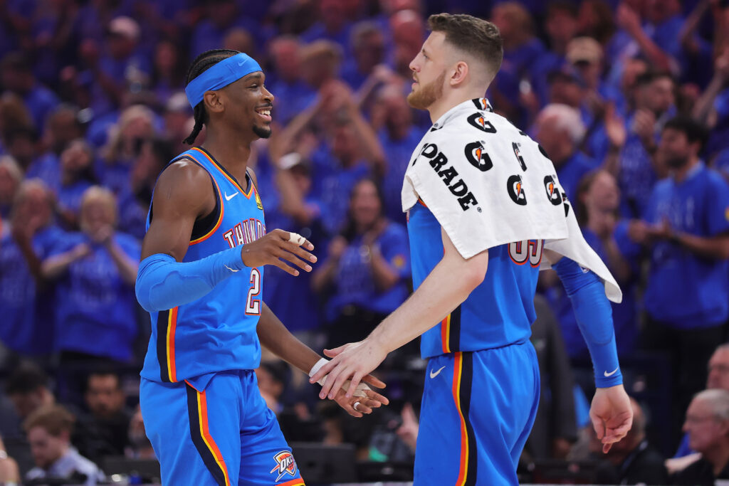 Shai Gilgeous-Alexander #2 and Isaiah Hartenstein #55 of the Oklahoma City Thunder react during the second quarter against the San Antonio Spurs in Game One of the NBA Western Conference Finals at Paycom Center.