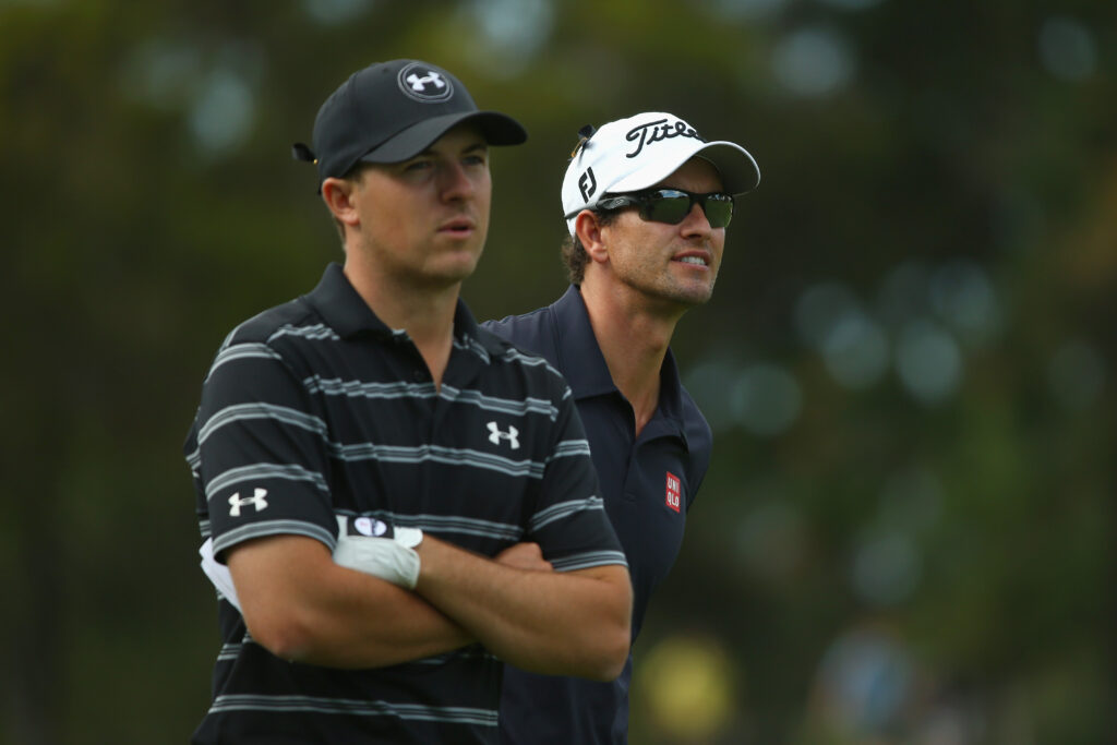 Jordan Speith of the USA and Aadm Scott of Australia watch on during day two of the Australian Open at The Australian Golf Course