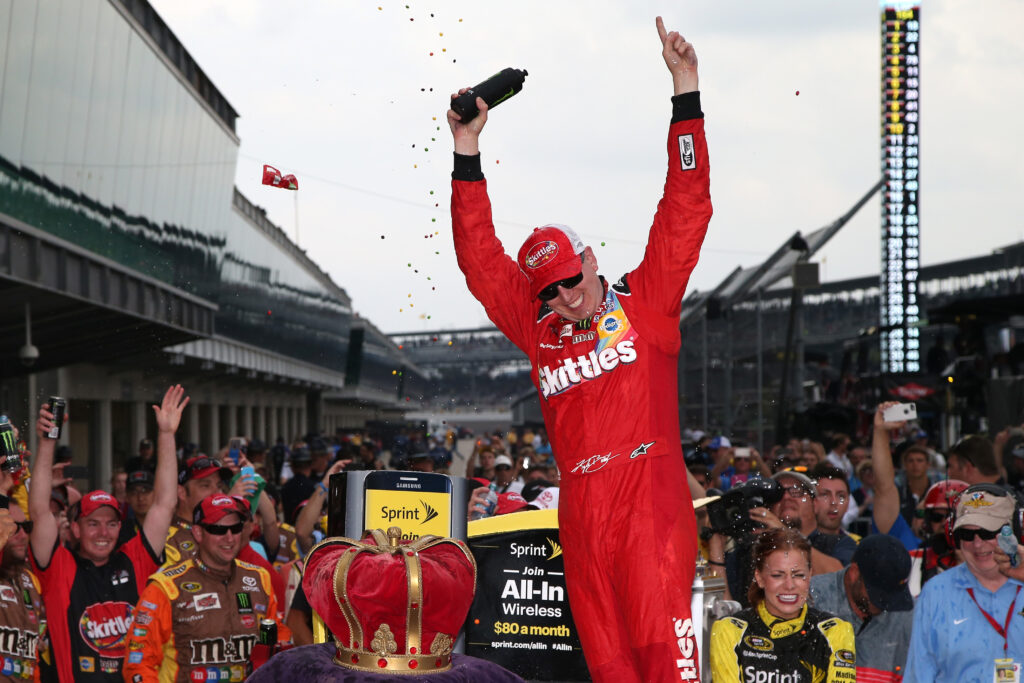 Kyle Busch, driver of the #18 Skittles Toyota, celebrates in Victory Lane after winning the NASCAR Sprint Cup Series Crown Royal Presents the Jeff Kyle 400 at the Brickyard at Indianapolis Motor Speedway on July 26, 2015 in Indianapolis, Indiana.