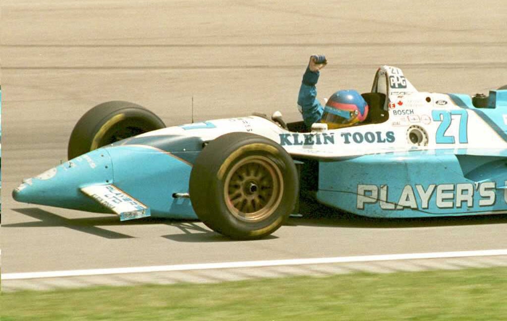 Canadian Indy car driver Jacques Villeneuve pumps his fist as he circles the track 28 May after winning the 79th Indianapolis 500. Villeneuve won the race in his second attempt.