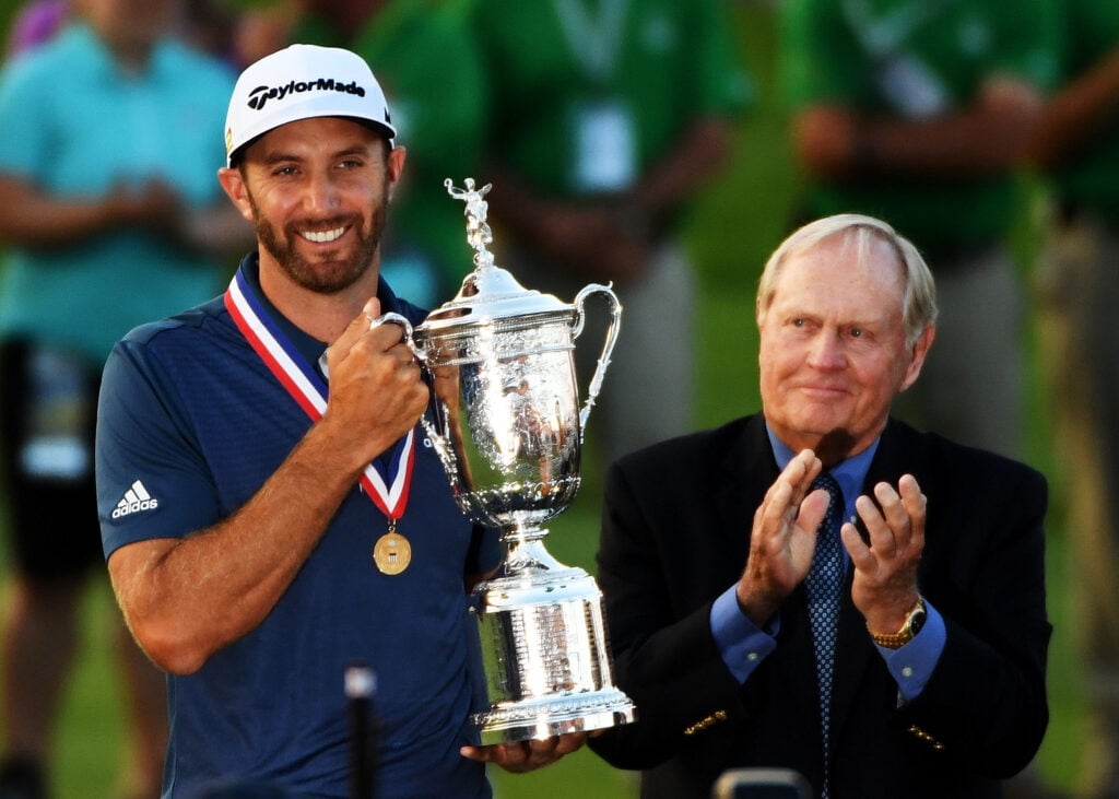 Dustin Johnson of the United States celebrates with the winner's trophy alongside Jack Nicklaus after winning the U.S. Open at Oakmont Country Club