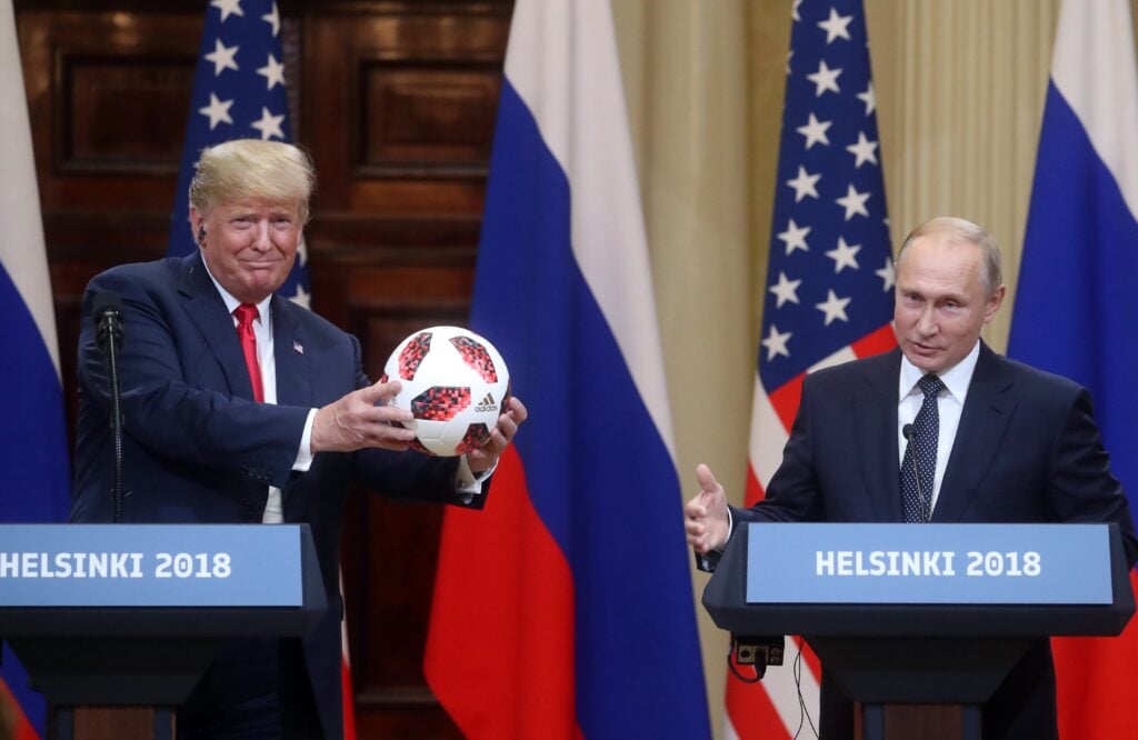 U.S. President Donald Trump (L) holds official FIFA World Cup 2018 ball presented by Russia's President Vladimir Putin (R) during a joint press conference after their bilateral meeting.