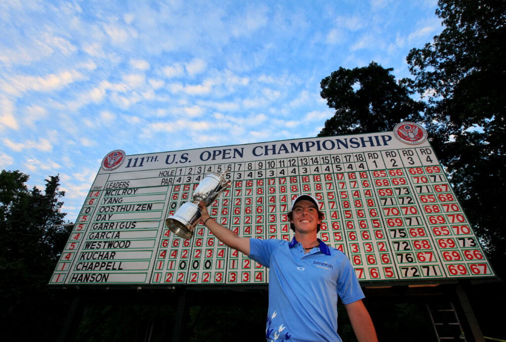Rory McIlroy of Northern Ireland poses with the trophy after his eight-stroke victory on the 18th green during the 111th U.S. Open
