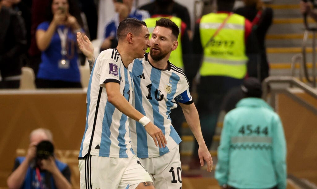 Lionel Messi of Argentina celebrates his first goal with Angel Di Maria (left) during the FIFA World Cup Qatar 2022 Final match between Argentina and France at Lusail Stadium.