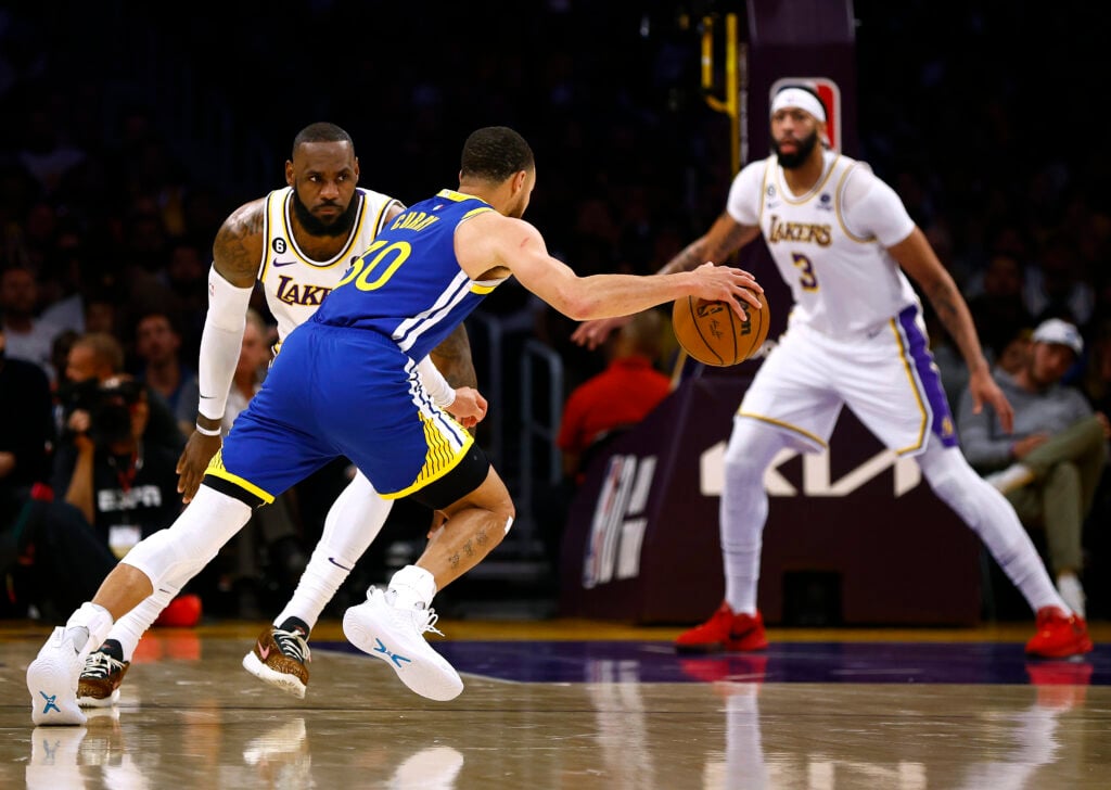 Stephen Curry #30 of the Golden State Warriors dribbles in front of LeBron James #6 and Anthony Davis #3 of the Los Angeles Lakers during the first half in game three of the Western Conference Semifinal Playoffs at Crypto.com Arena on May 06, 2023 in Los Angeles, California.