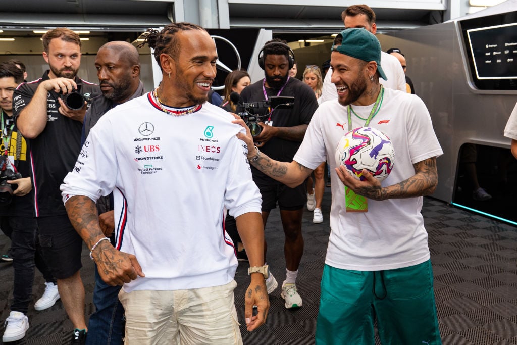 Mercedes AMG F1 driver Lewis Hamilton shares a joke with Brazilian footballer Neymar during previews ahead of the F1 Grand Prix of Spain