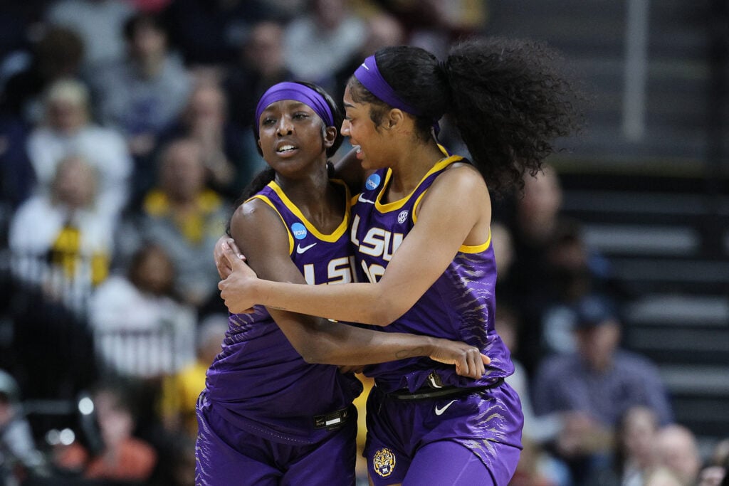 Angel Reese #10 of the LSU Tigers and Flau'jae Johnson #4 of the LSU Tigers celebrate in a game against the UCLA Bruins during the second half in the Sweet 16 round of the NCAA Women's Basketball Tournament at MVP Arena.